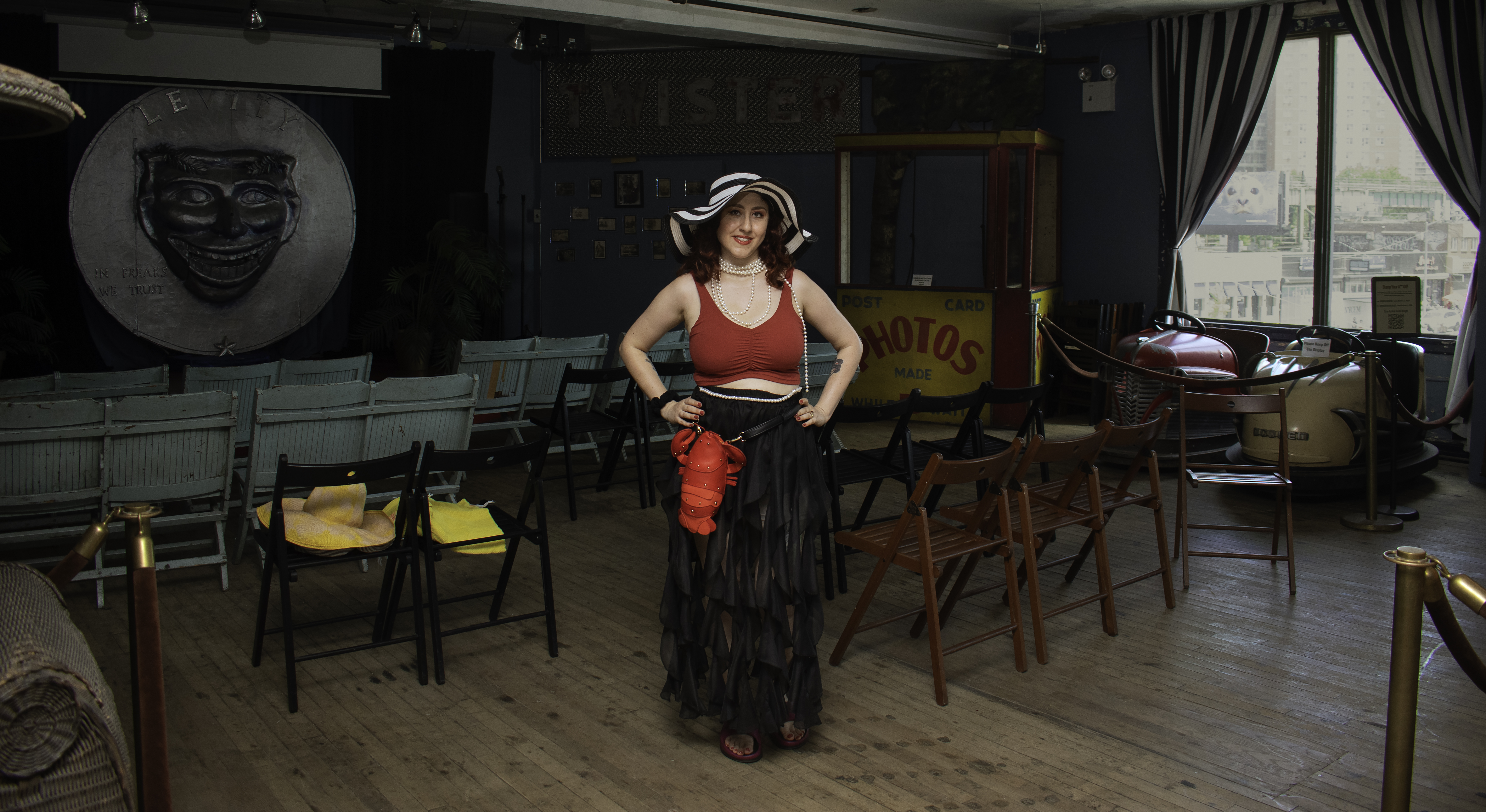 Keri Sheheen painting a vibrant parade banner inside the studio